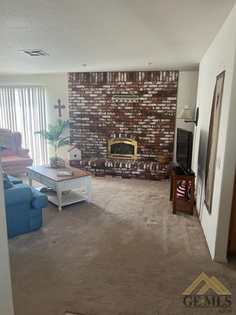 Undisclosed Address Tehachapi, CA 93561 - Photo 7 of 28 a living room with furniture a flat screen tv and a fireplace