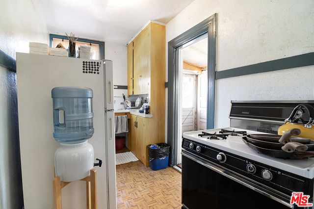 a dining room with furniture a chandelier and wooden floor