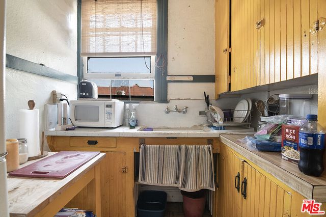 a bedroom with a bed and large windows