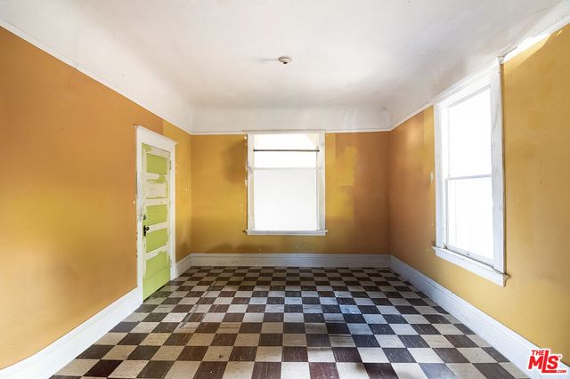 a open kitchen with windows and refrigerator