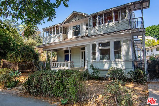front view of a brick house with a small yard