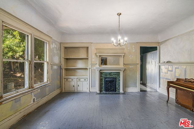 a view of a livingroom with wooden floor and a ceiling fan