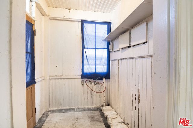 a view of a livingroom with wooden floor and a window