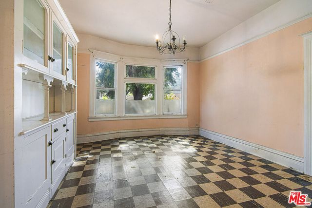 a kitchen that has a sink a stove and cabinets