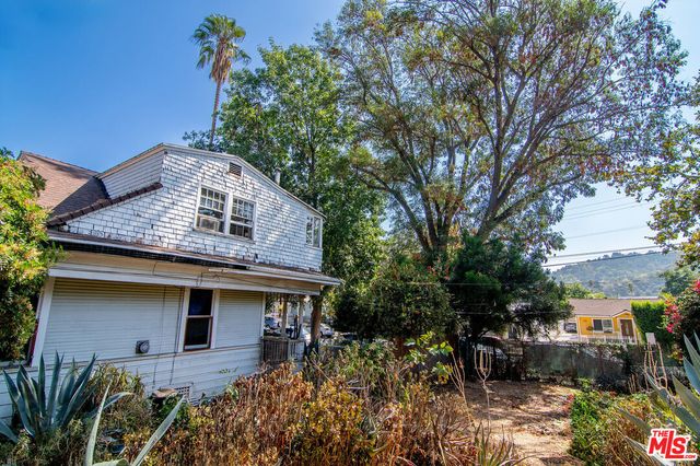 a backyard of a house with outdoor seating and green space