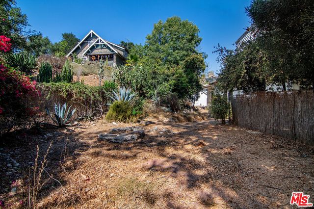 a view of a chairs and table in the backyard