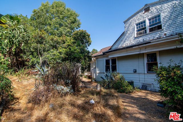 front view of a house with a tree