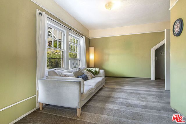 a view of a bedroom with a bed and a window