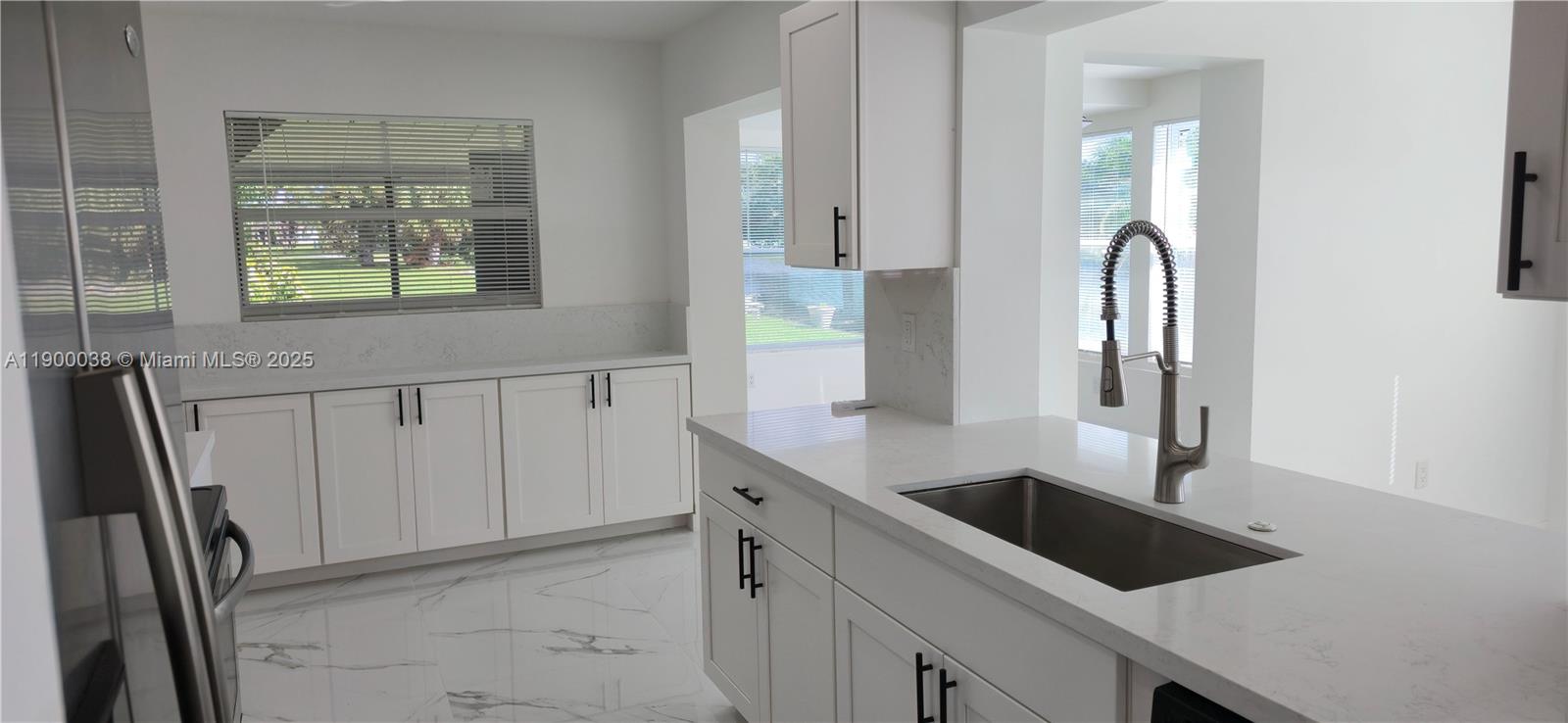 4404 Northwest 46th Way, Unit 4404 Tamarac, FL 33319 - Photo 13 of 27 a kitchen with a sink and a refrigerator