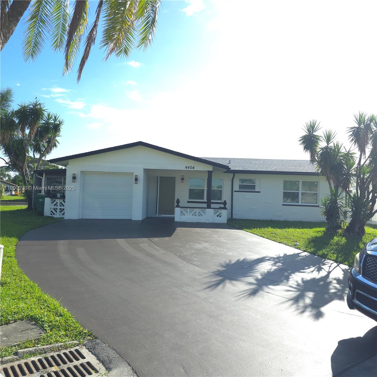 4404 Northwest 46th Way, Unit 4404 Tamarac, FL 33319 - Photo 2 of 27 a front view of a house with a yard and garage