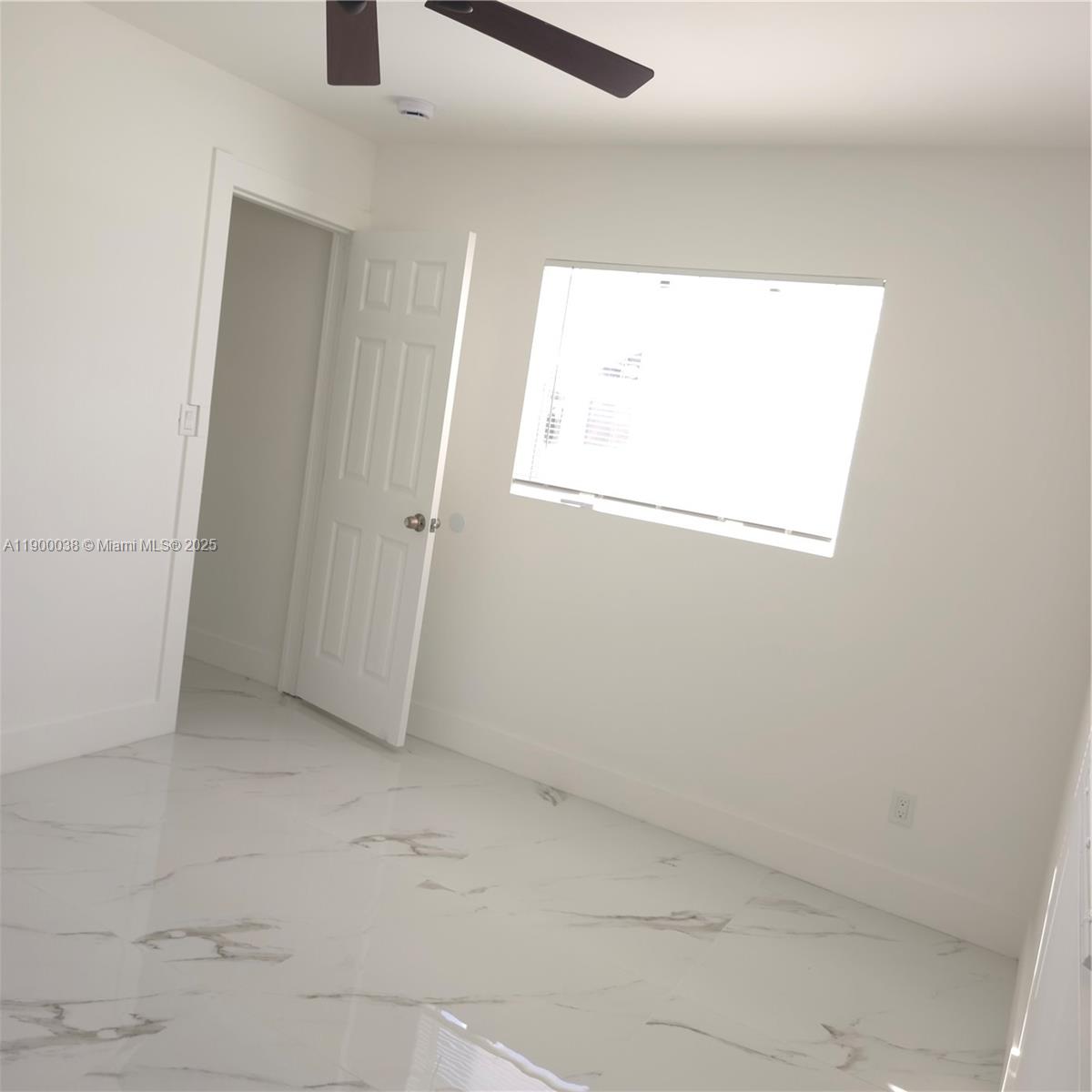 4404 Northwest 46th Way, Unit 4404 Tamarac, FL 33319 - Photo 5 of 27 an empty room with a window