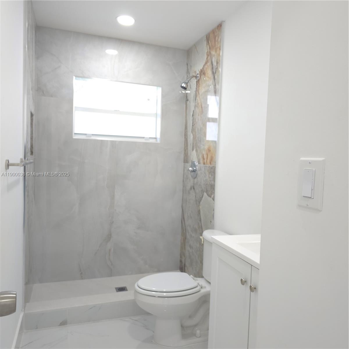 4404 Northwest 46th Way, Unit 4404 Tamarac, FL 33319 - Photo 7 of 27 a bathroom with a toilet and a shower