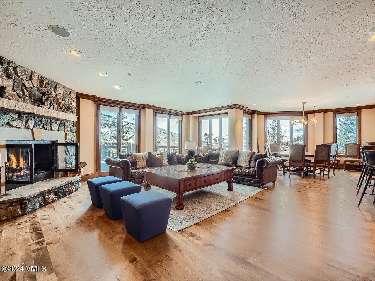 62 Highlands Lane, Unit R306 Beaver Creek, CO 81620 - Photo 1 of 32 a living room with furniture and a fireplace