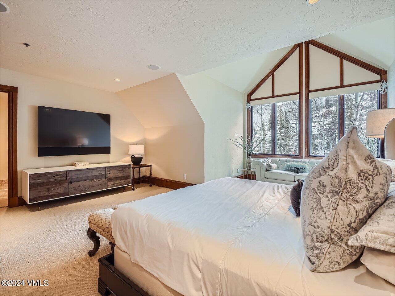 62 Highlands Lane, Unit R306 Beaver Creek, CO 81620 - Photo 11 of 32 a bedroom with a bed and a flat screen tv