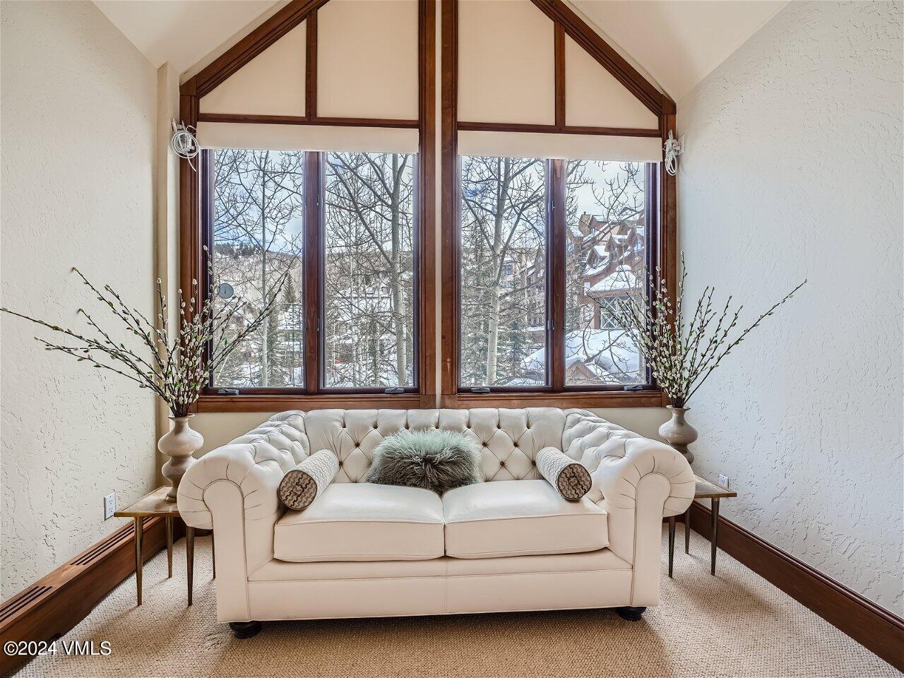 62 Highlands Lane, Unit R306 Beaver Creek, CO 81620 - Photo 12 of 32 a living room with furniture and a large window