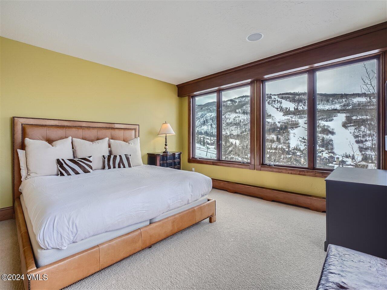 62 Highlands Lane, Unit R306 Beaver Creek, CO 81620 - Photo 15 of 32 a bedroom with a bed and a large window