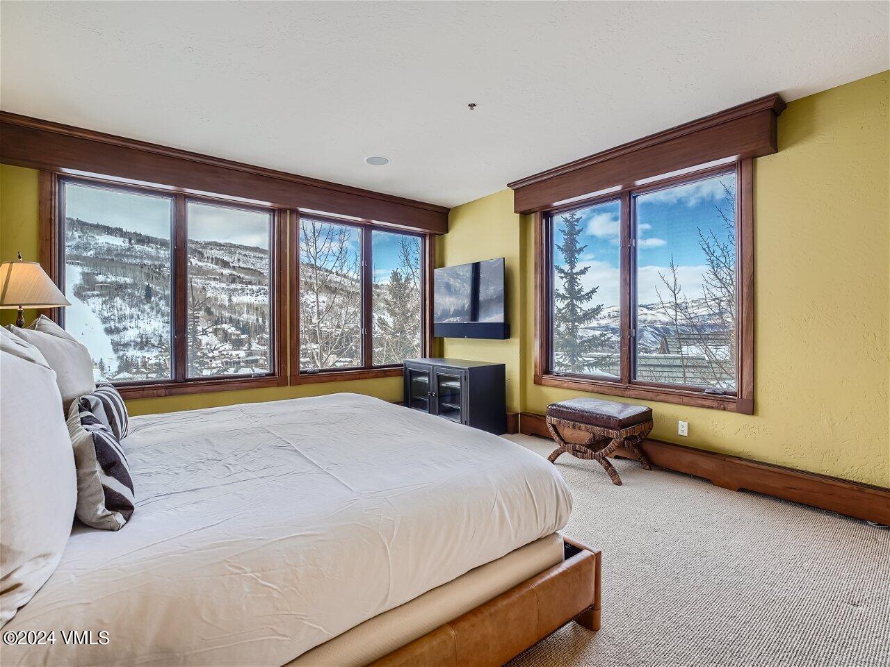 62 Highlands Lane, Unit R306 Beaver Creek, CO 81620 - Photo 16 of 32 a bed room with a bed and a chair