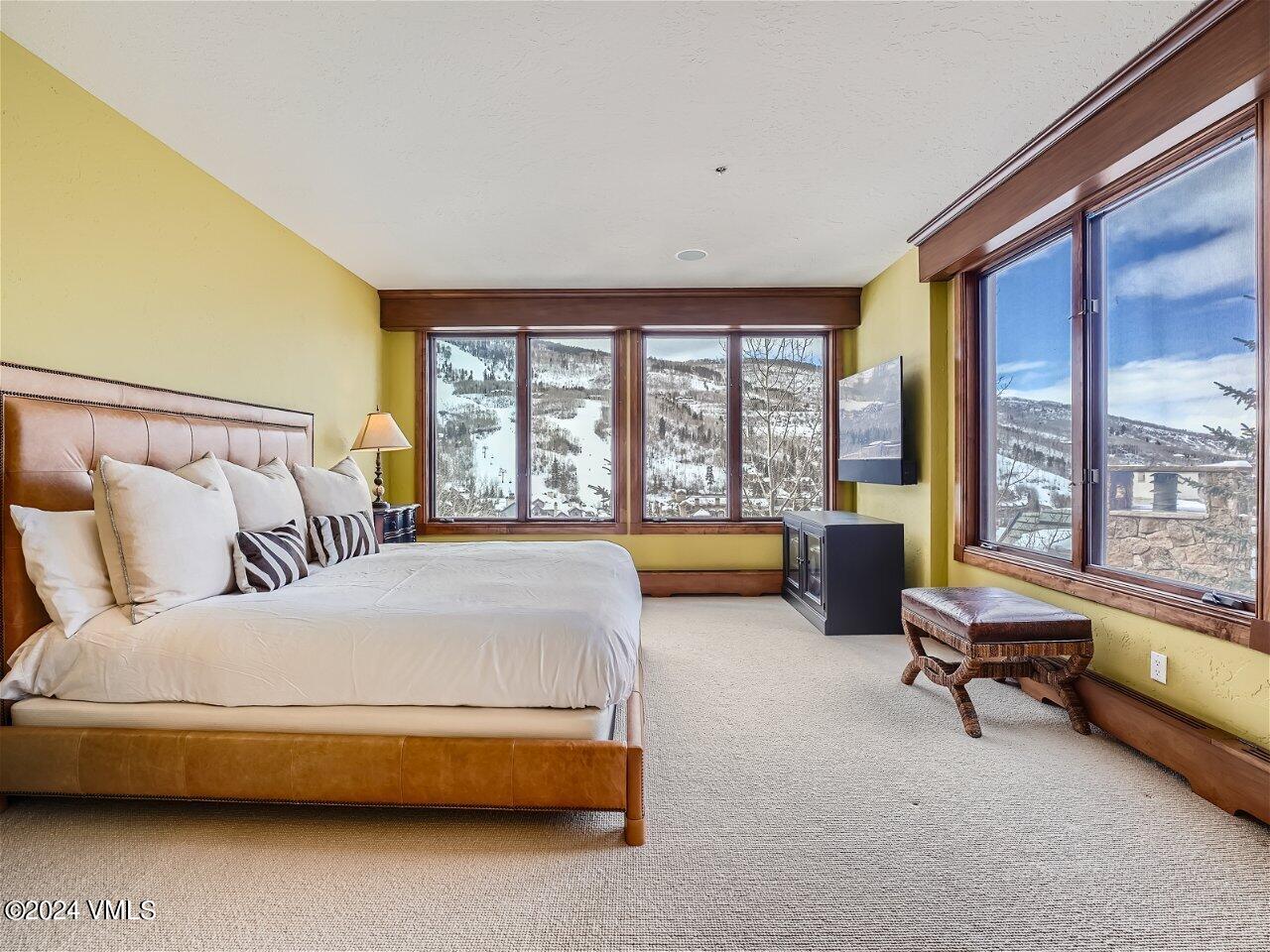 62 Highlands Lane, Unit R306 Beaver Creek, CO 81620 - Photo 17 of 32 a bedroom with a bed and a couch next to a window