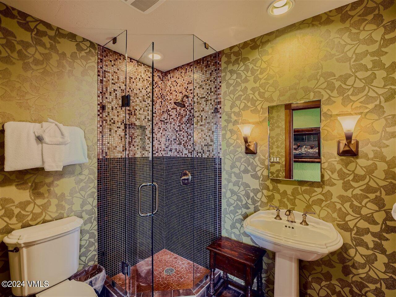 62 Highlands Lane, Unit R306 Beaver Creek, CO 81620 - Photo 18 of 32 a bathroom with a sink and mirror with toilet