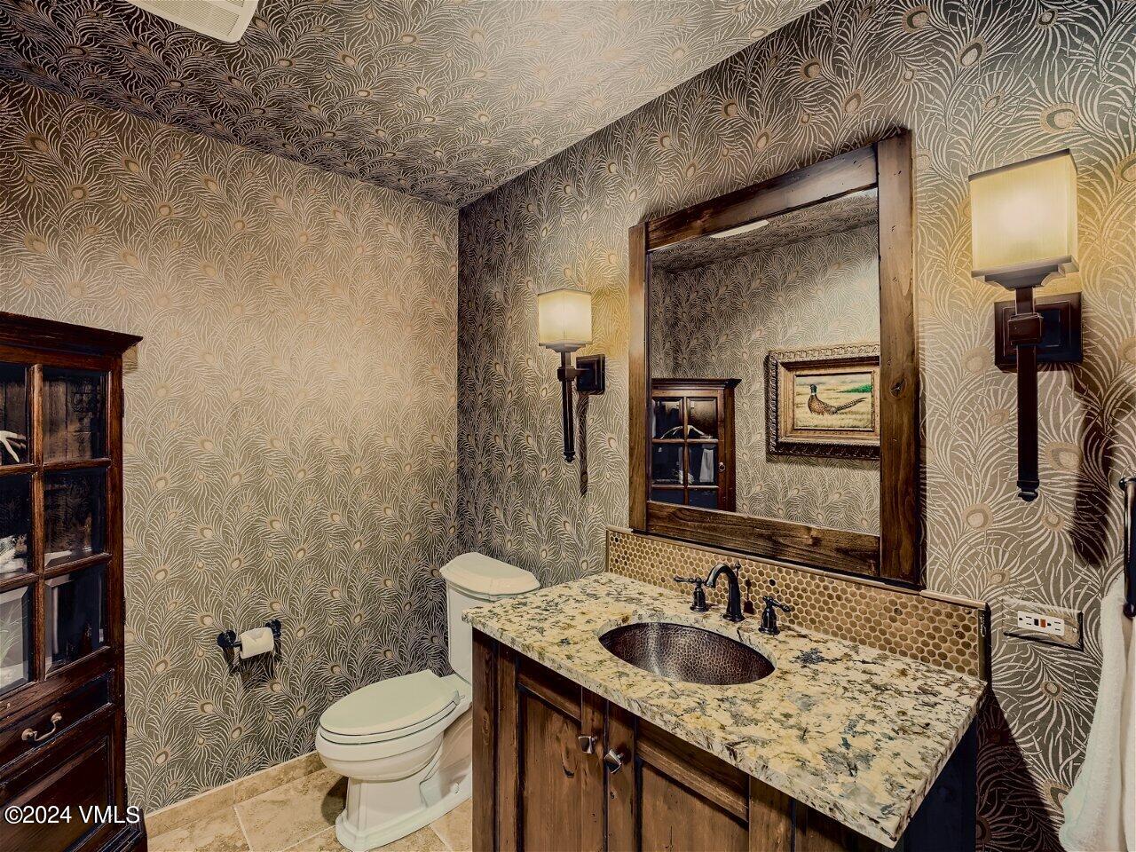 62 Highlands Lane, Unit R306 Beaver Creek, CO 81620 - Photo 21 of 32 a bathroom with a granite countertop sink and a toilet