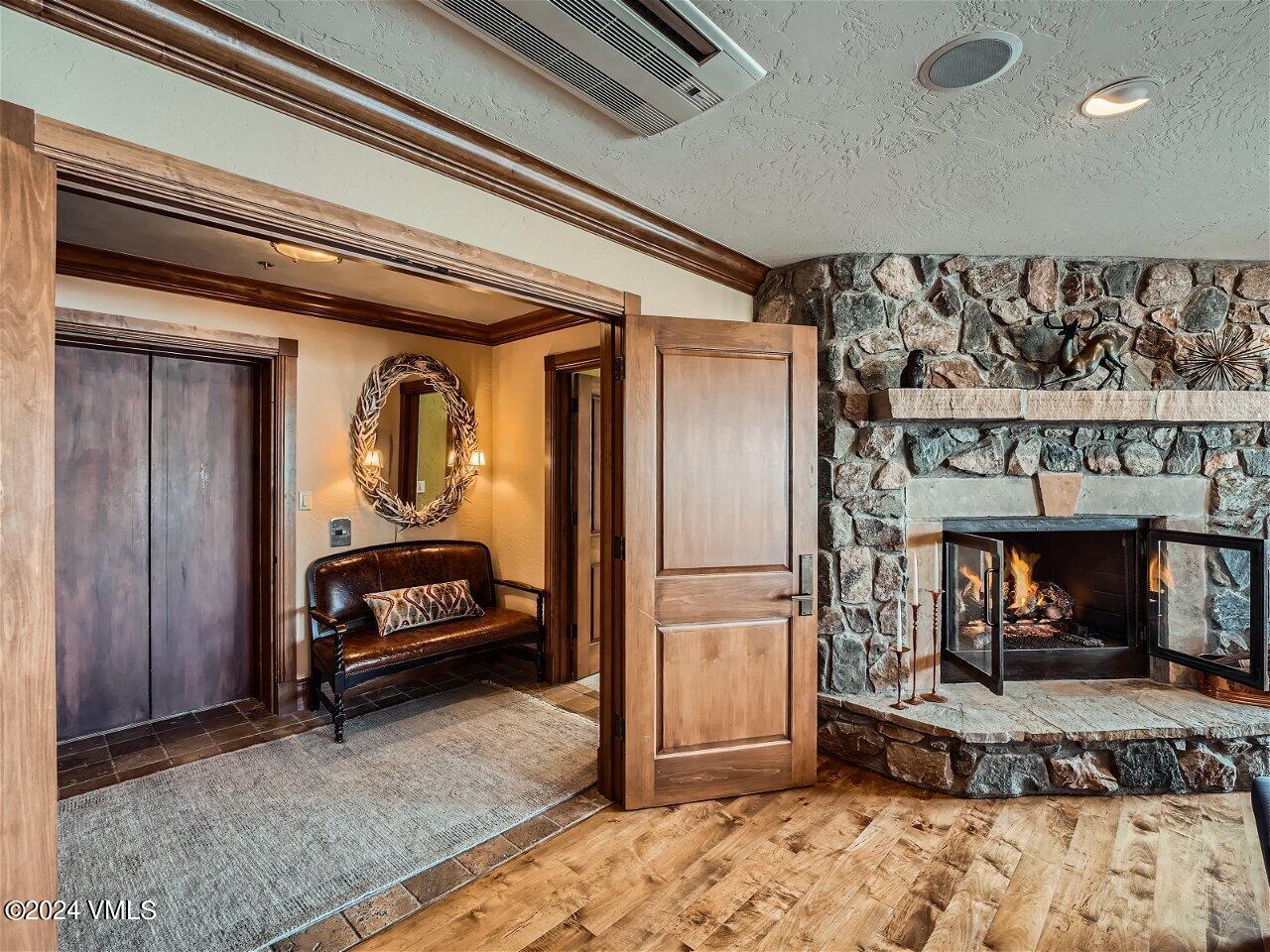 62 Highlands Lane, Unit R306 Beaver Creek, CO 81620 - Photo 23 of 32 a living room with a couch and a fireplace
