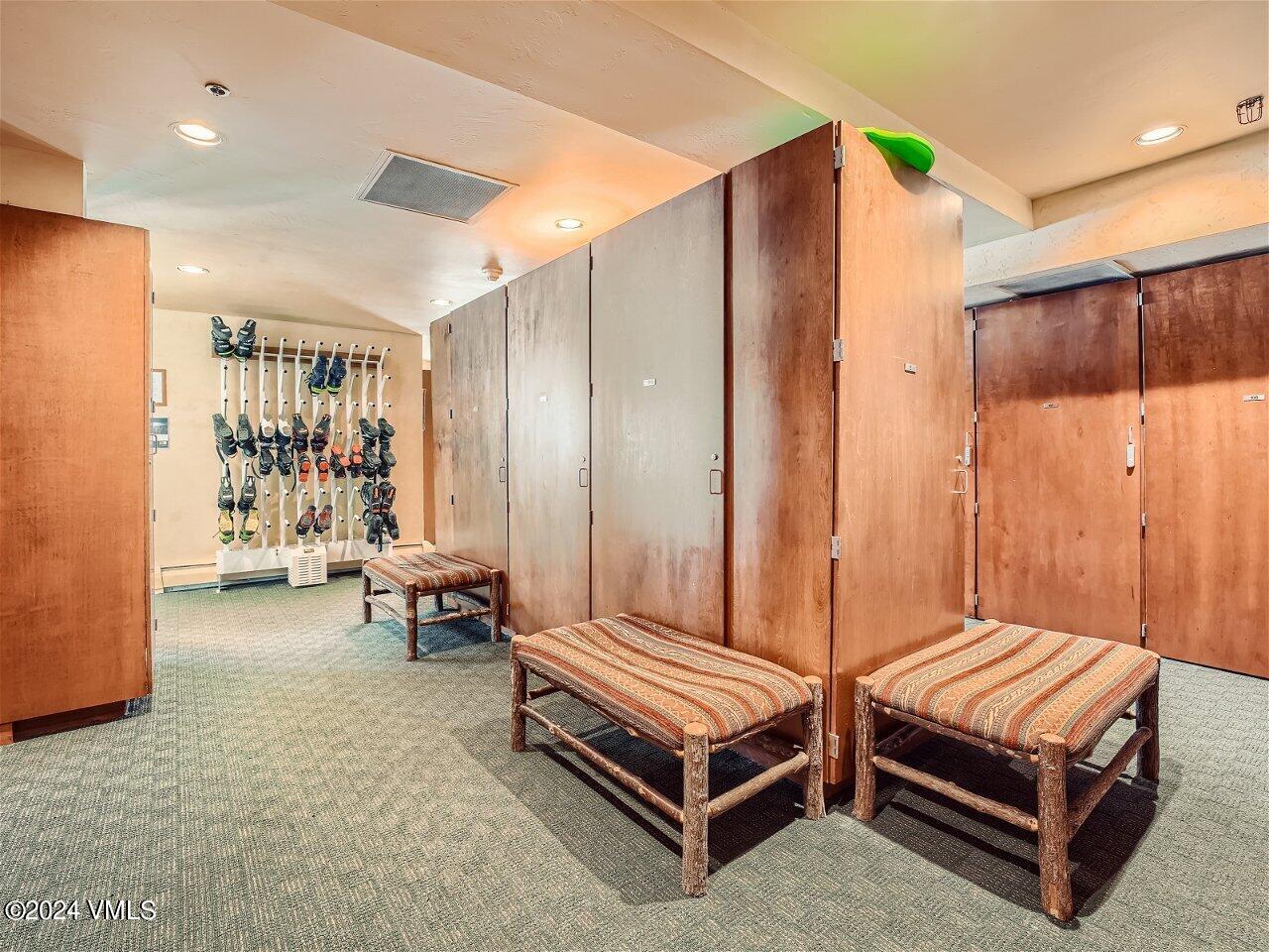 62 Highlands Lane, Unit R306 Beaver Creek, CO 81620 - Photo 25 of 32 a bedroom with a bed and a chair