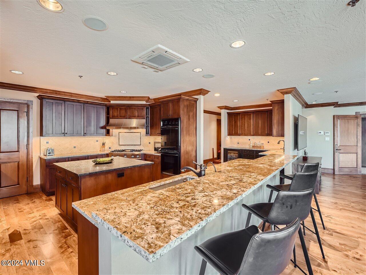 62 Highlands Lane, Unit R306 Beaver Creek, CO 81620 - Photo 3 of 32 a kitchen with a stove and a refrigerator