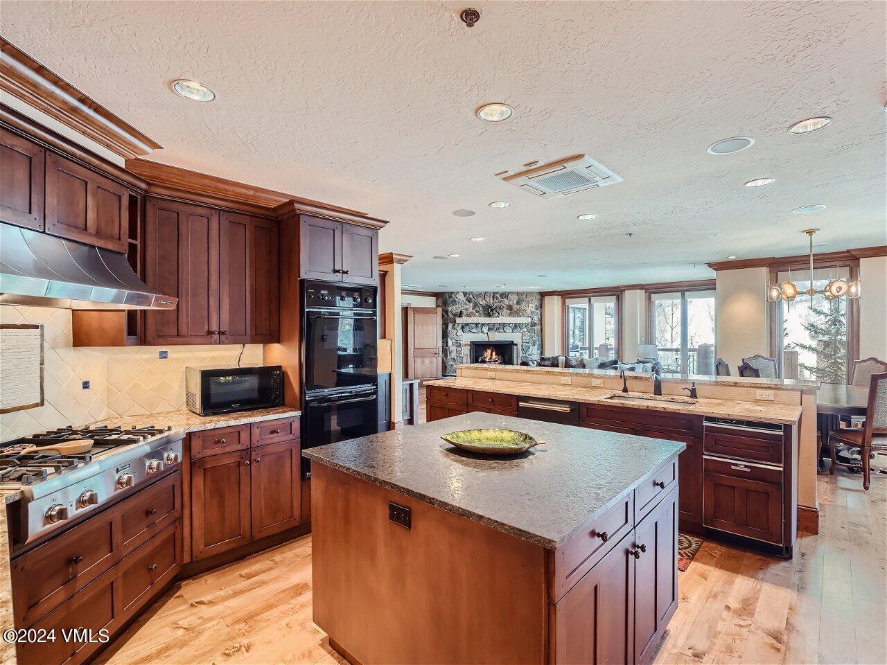 62 Highlands Lane, Unit R306 Beaver Creek, CO 81620 - Photo 4 of 32 a kitchen with a stove a sink a refrigerator and cabinets