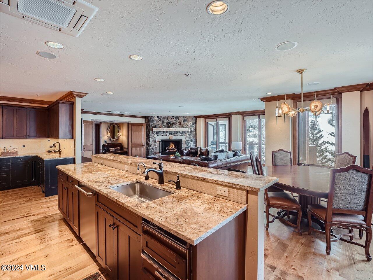 62 Highlands Lane, Unit R306 Beaver Creek, CO 81620 - Photo 6 of 32 a large kitchen with kitchen island a sink table and chairs
