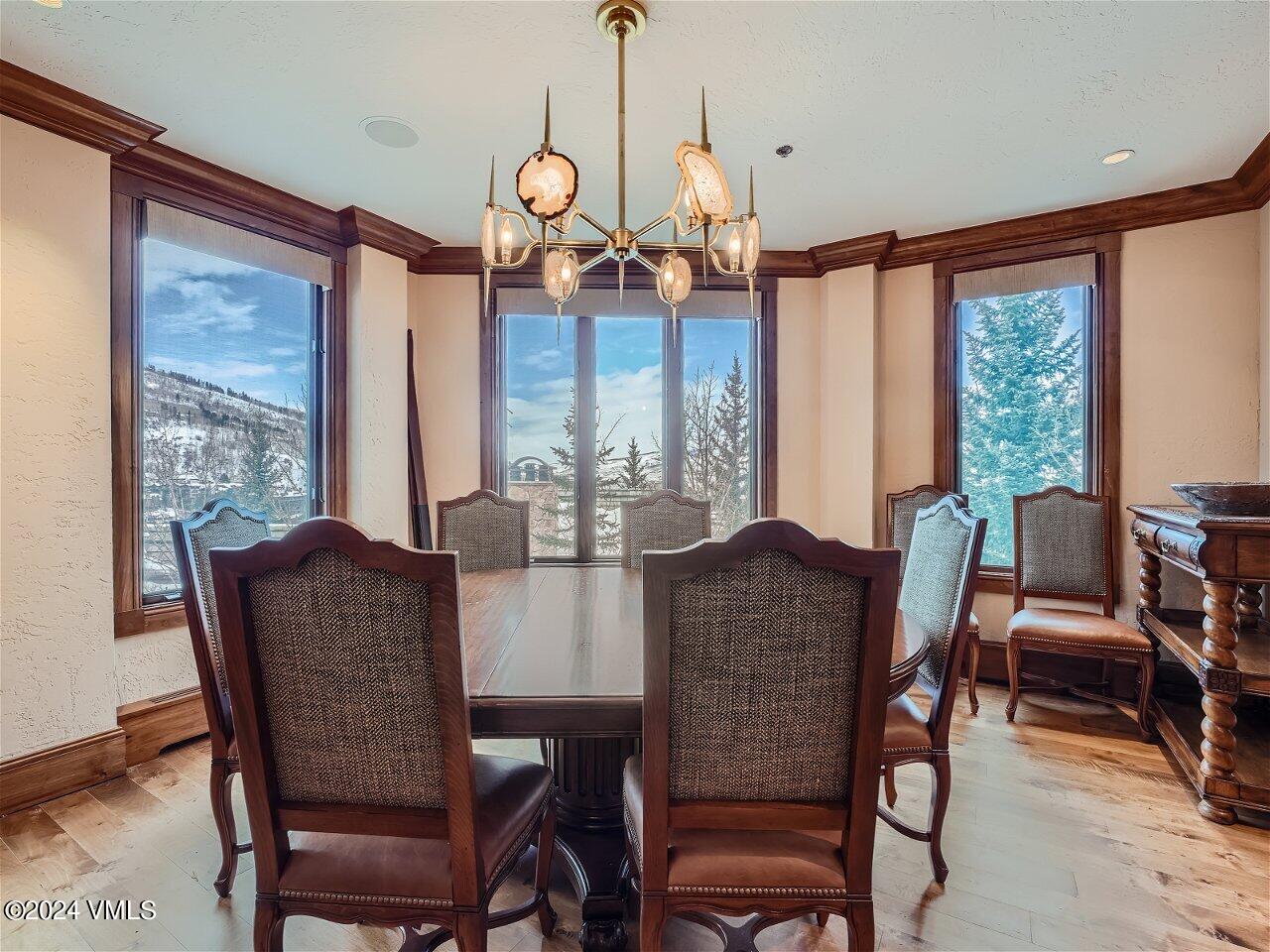 62 Highlands Lane, Unit R306 Beaver Creek, CO 81620 - Photo 9 of 32 a dining room with furniture a chandelier and wooden floor