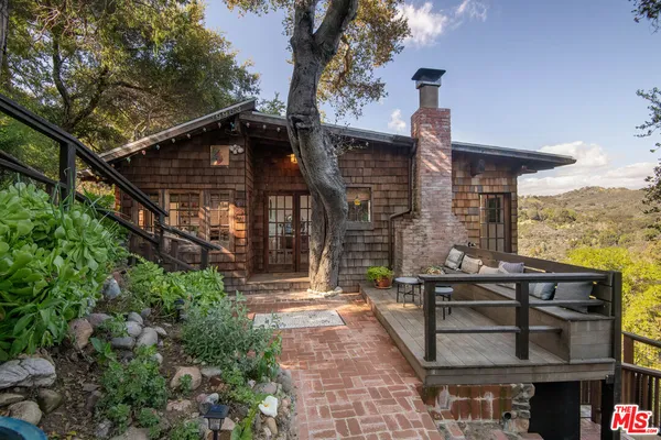 a view of house with outdoor space and sitting area