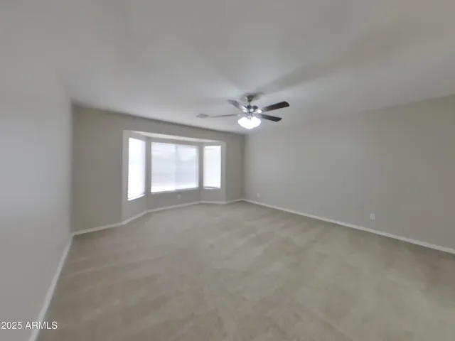 a large kitchen with a large counter top a sink stainless steel appliances and cabinets