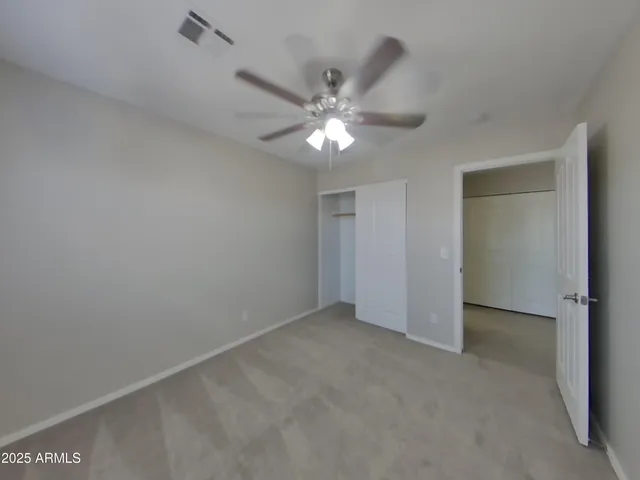 a white toilet sitting next to a bathroom sink and vanity