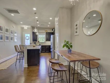 a living room with furniture and kitchen view