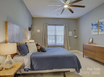 a bedroom with a bed and ceiling fan