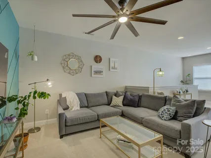 a living room with furniture and a painting