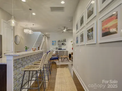 a kitchen with stainless steel appliances kitchen island granite countertop a stove a sink and a microwave