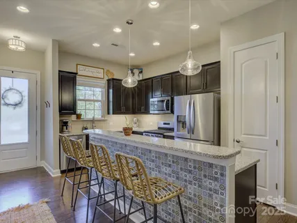 a kitchen with granite countertop stainless steel appliances granite countertop wooden cabinets and a granite counter tops