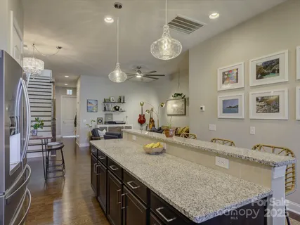 a kitchen with granite countertop a stove and a microwave