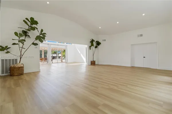 a view of an empty room and wooden floor