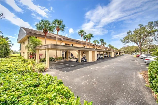 a view of a house with a yard and pathway