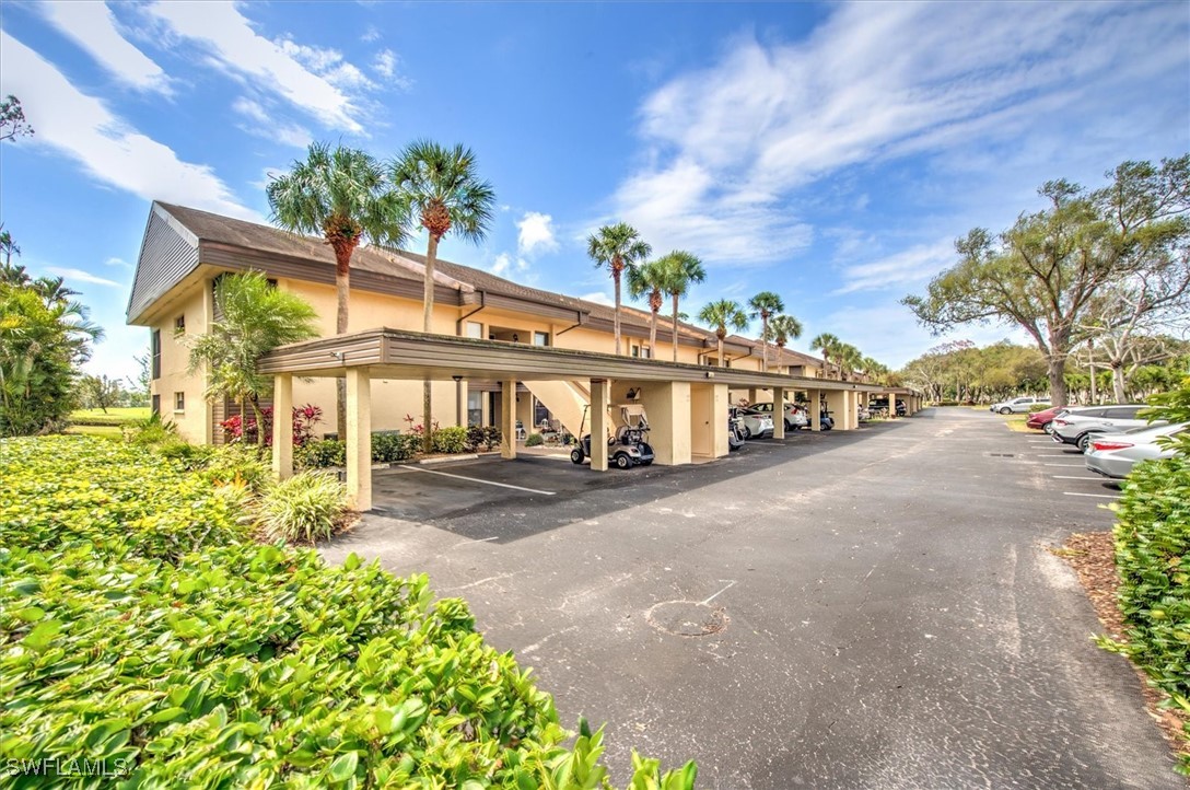 a view of a house with a yard and pathway