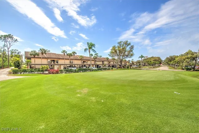 a view of yard with swimming pool and green space