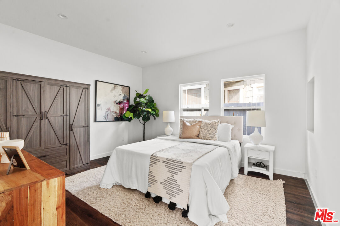 2209 West Boulevard Los Angeles, CA 90016 - Photo 12 of 29 a bedroom with a bed and a flat screen tv