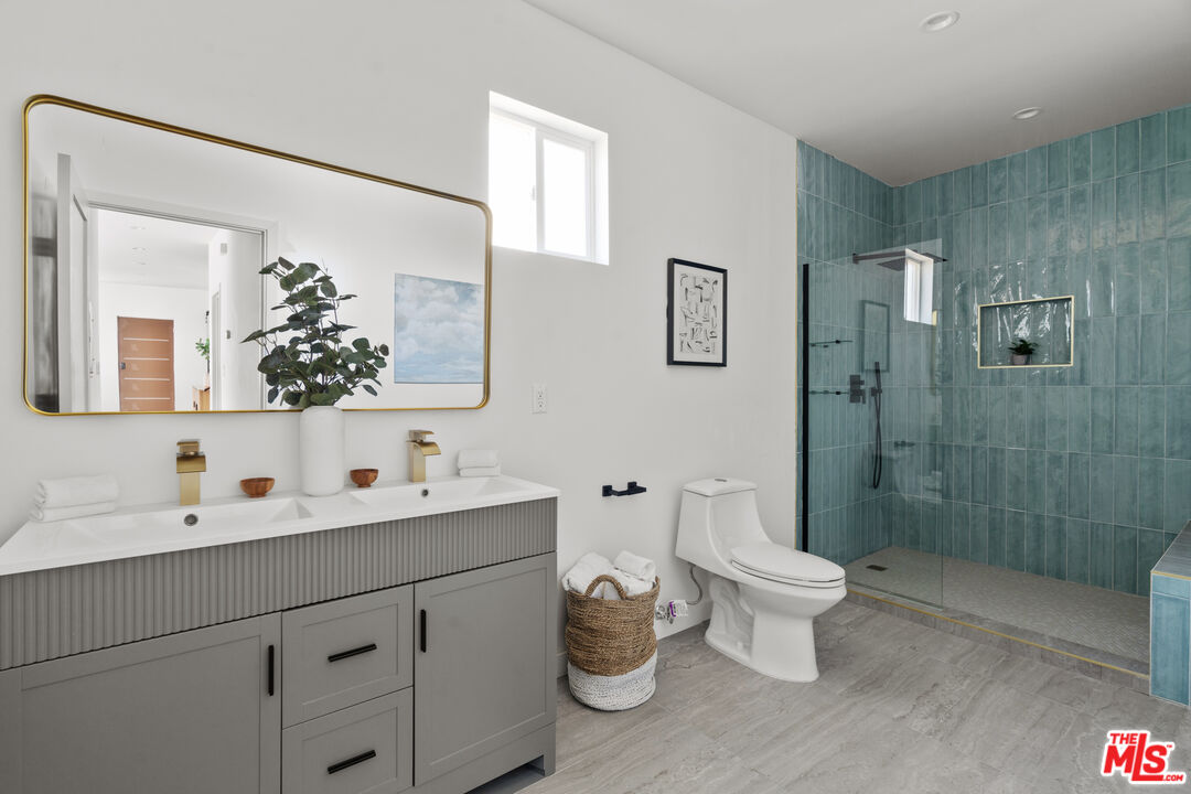 2209 West Boulevard Los Angeles, CA 90016 - Photo 13 of 29 a bathroom with a double vanity sink mirror and toilet