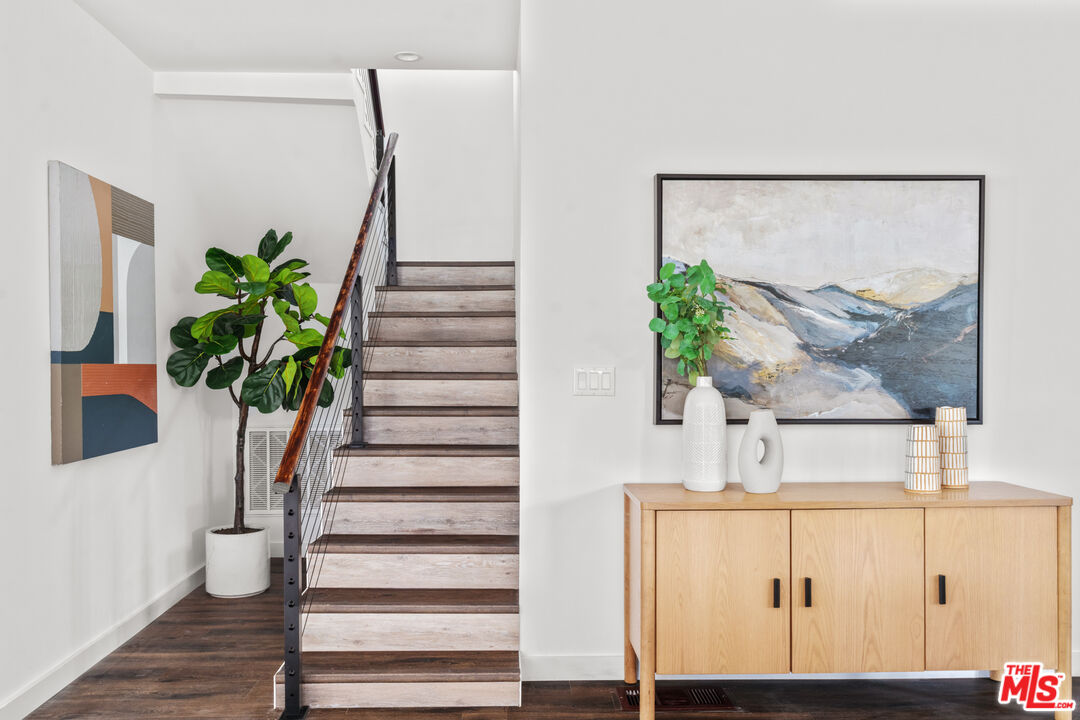 2209 West Boulevard Los Angeles, CA 90016 - Photo 16 of 29 a vase of flowers sitting on a table with wooden floor