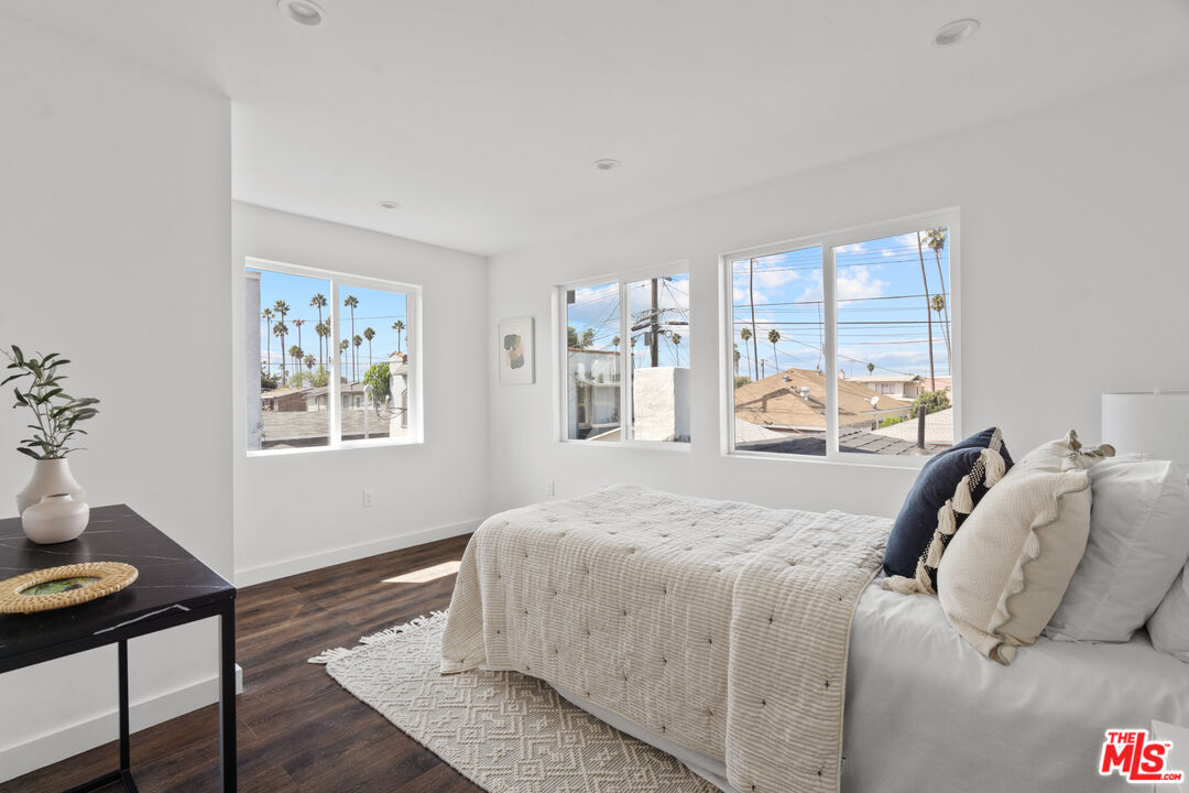 2209 West Boulevard Los Angeles, CA 90016 - Photo 19 of 29 a bedroom with a bed and wooden floor