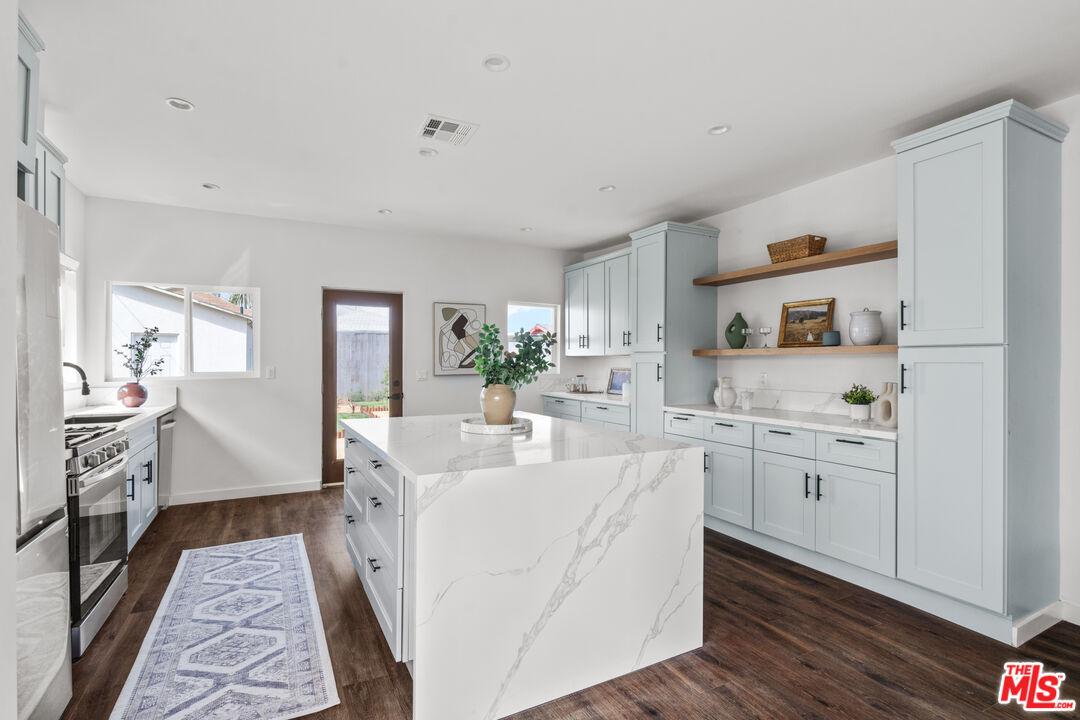 2209 West Boulevard Los Angeles, CA 90016 - Photo 6 of 29 a large white kitchen with cabinets
