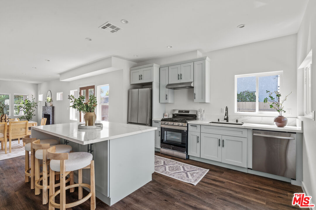 2209 West Boulevard Los Angeles, CA 90016 - Photo 7 of 29 a kitchen with stainless steel appliances granite countertop a sink stove and refrigerator