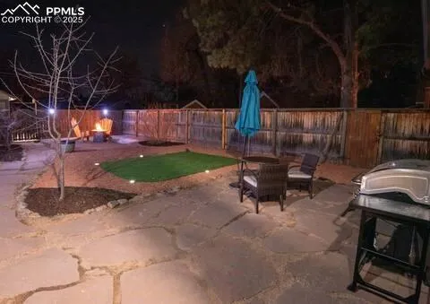 a backyard of a house with table and chairs